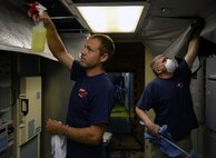 Dustin Barnes, left, and Kim Barnes, co-owners of a Great Falls cleaning company, clean the ceiling panels of a launch control center at a missile alert facility near Malmstrom Air Force Base, Mont. May 4, 2015., The Barnes’ are contracted to clean each of the LCC’s as part of an effort to improve quality of life for the missileers who work in them. (U.S. Air Force photo/Airman 1st Class Dillon Johnston)