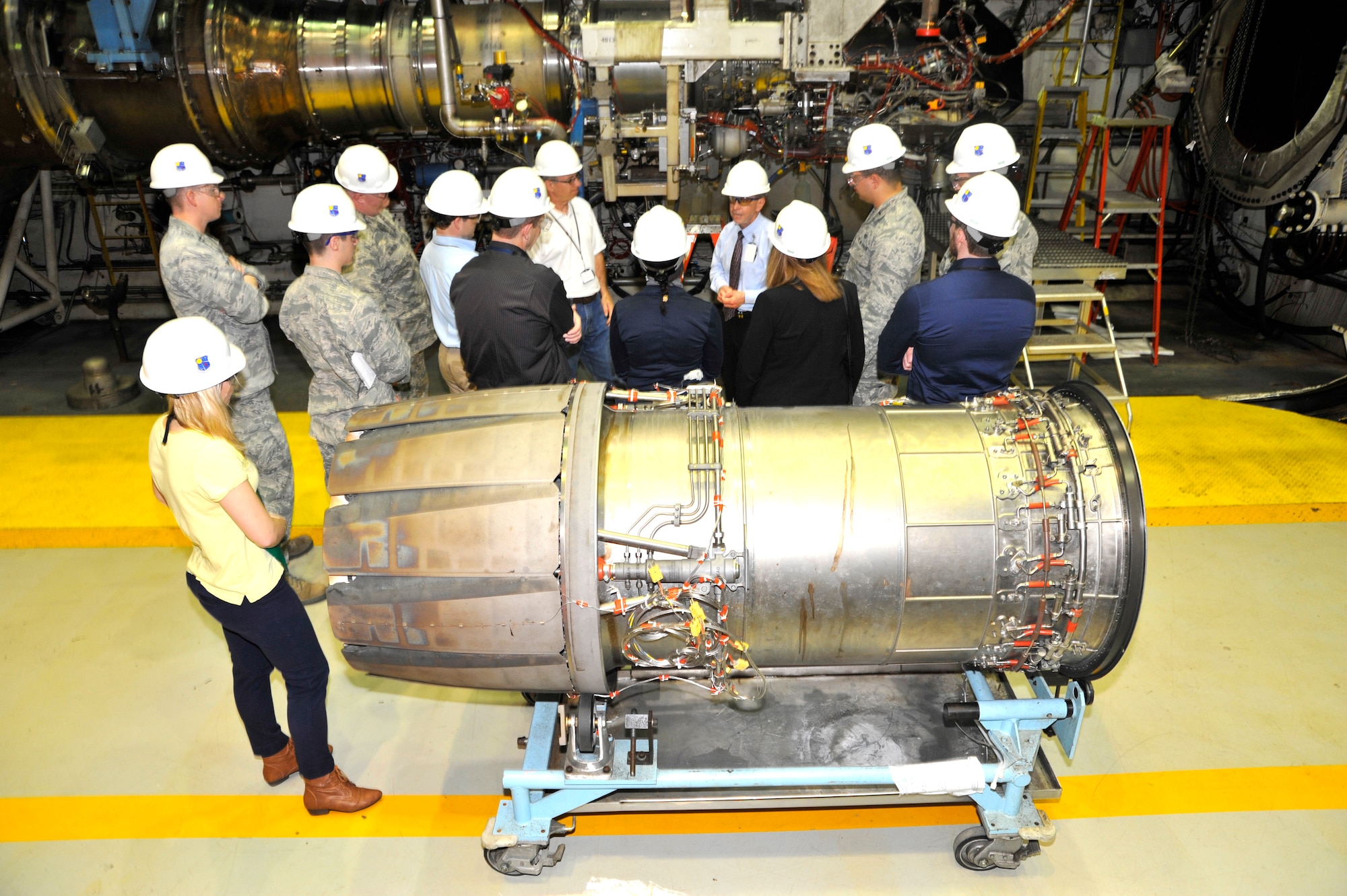 Members of the Air Force Research Laboratory Materials and Manufacturing Directorate (AFRL/RX) at Wright Patterson AFB recently visited AEDC to tour the test facilities and get an understanding of their capabilities. Here is the group inside of Jet Engine Test Cell J-1 listening as Gene Klingensmith, AEDC project manager, and Mike Dent, AEDC deputy director of the Aeropropulsion Test Branch, (both in center back) speak about the test cell. (Photo by Rick Goodfriend)