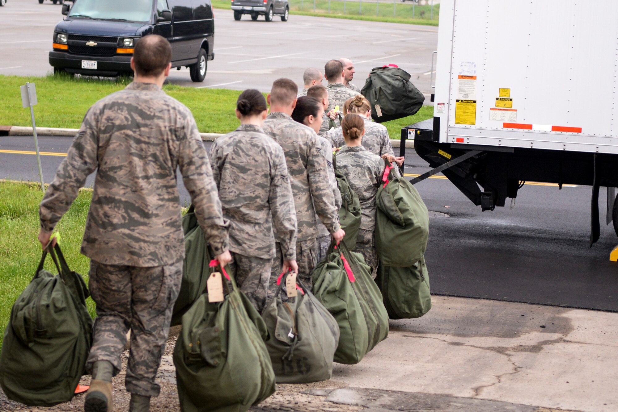 Airmen load their mobility bags onto a waiting cargo truck after processing through the mobility bag issue line as part of a base exercise at Wright-Patterson Air Force Base, Ohio, May 5, 2015. The 88th Air Base Wing routinely conducts readiness exercises to test and enhance skills and proficiency. 

The Skywrighter will have complete coverage of the exercise in the May 15 edition.

(U.S. Air Force photo by Wesley Farnsworth/Released)