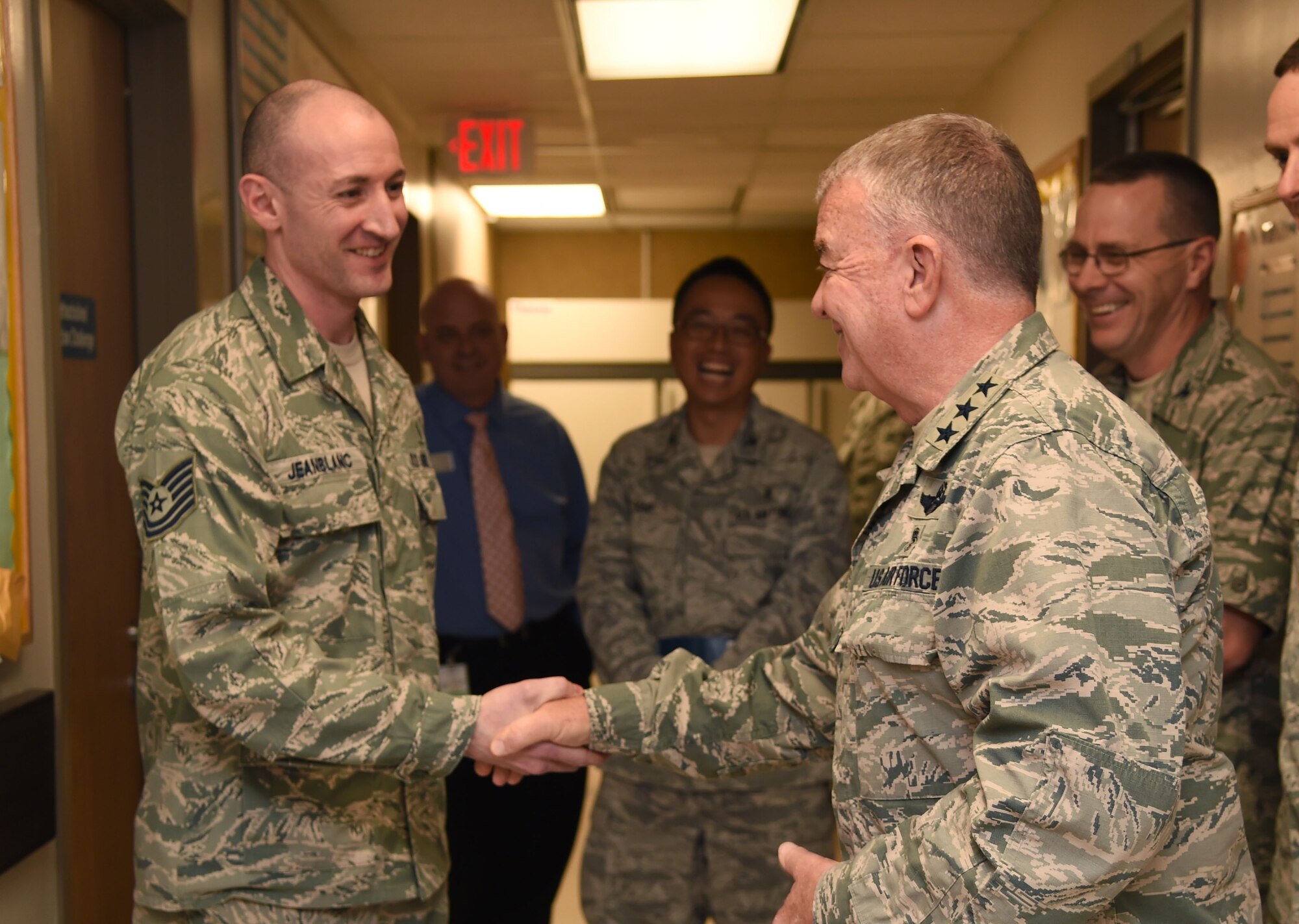 Air Force Surgeon General Lt. Gen. (Dr.) Thomas Travis presents a coin to Tech. Sgt. Corey Jeanblanc May 7, 2015 during a visit to the Wilford Hall Ambulatory Surgical Center, Joint Base San Antonio-Lackland, Texas. Jeanblanc was among 14 Airmen recognized by the surgeon general for outstanding performance within their units. (U.S. Air Force photo/Staff Sgt. Jerilyn Quintanilla)