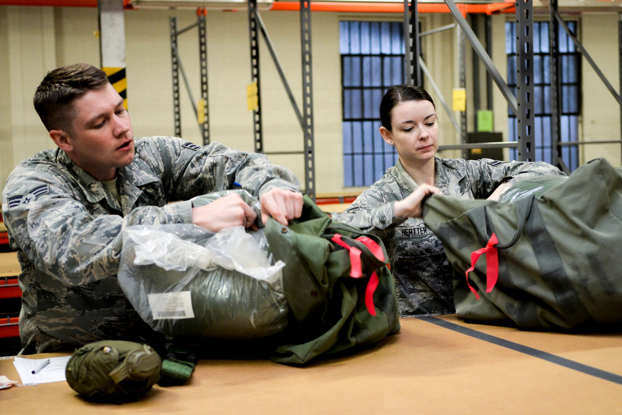 U.S. Air Force Senior Airman Michael Hutson, 88th Medical Support Group medical technician, and Airman 1st Class Anastasia Hertter, 88th Air Base Wing executive administration journeyman, place their sleeping bags into their bags during the gear issue portion of mobility exercise at Wright-Patterson Air Force Base, Ohio, May 5, 2015. In addition to having gear issued, Airmen processed through the mobility line in an effort to ensure all paperwork and required information is up to date in case they were needed for a real world deployment. 

The May 15 edition of the Skywrighter will have complete coverage of the exercise.

(U.S. Air Force photo by Wesley Farnsworth/Released)