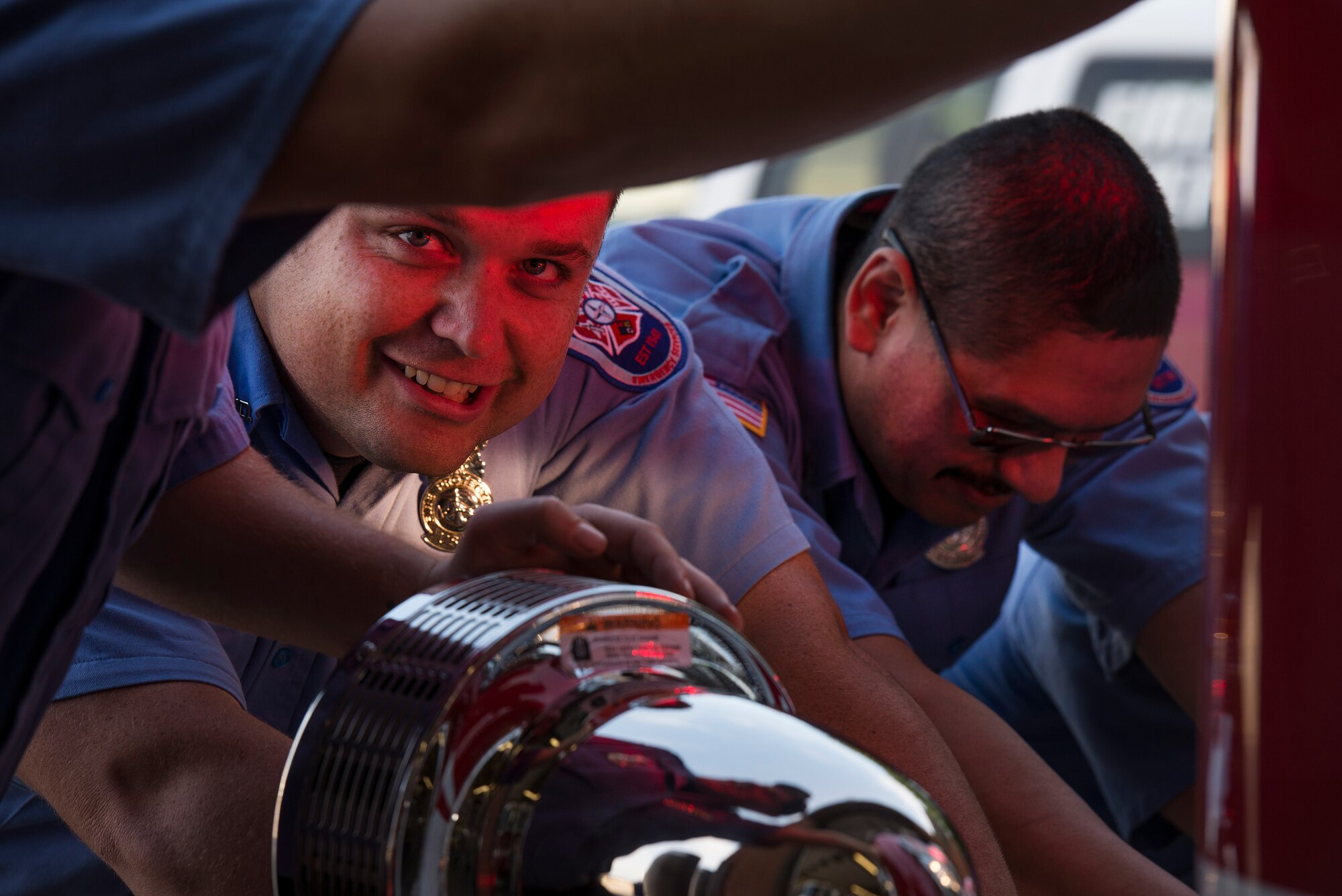 Cory Brinkley, (left), and Lt. R.J. Rivera, (right), both firefighters from the 82nd Training Wing fire department, aid in pushing a new Protection-22 engine into the fire station at Sheppard Air Force Base, Texas, during a housing ceremony May 8, 2015. The new engine is equipped with a compressed air foam system and seats up to five firefighters. The truck also has a feature that shuts down the engine if left idle for two minutes. This causes its generator to turn on and provide the necessary power to continue functioning. (U.S. Air Force photo by Senior Airman Kyle Gese/Released)