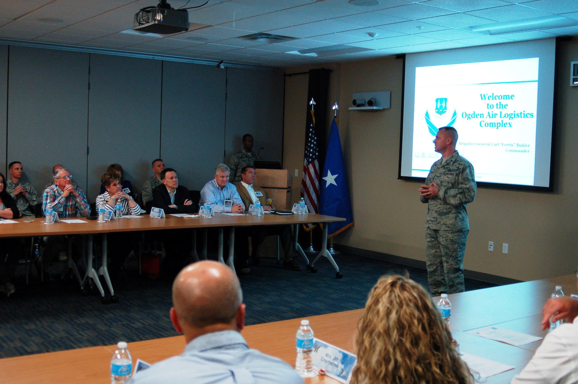 Brig. Gen. Carl Buhler, Ogden Air Logistics Complex commander, speaks to a group of 24 visitors, including state, local and federal leaders, who learned about the ALC's "Road to 30 Percent Depot Flow Day Reduction." (U.S. Air Force photo)