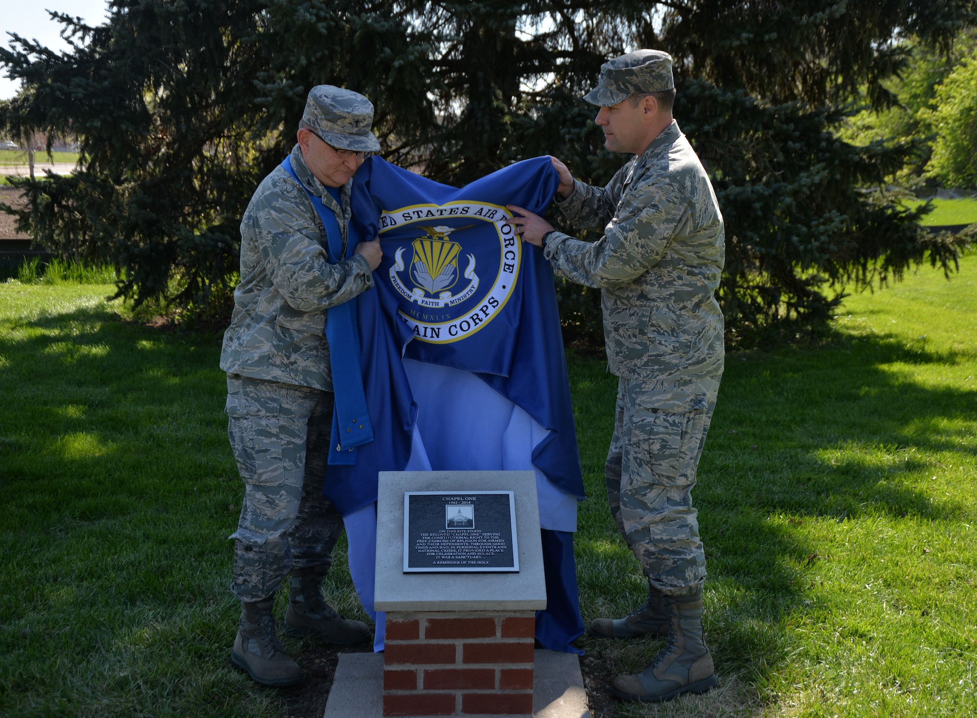 Col. Kenneth Crooks, Air Force Materiel Command 88th Air Base Wing Chaplain and Col. John Devillier, Air Force Materiel Command 88th Air Base Wing Commander unveil the memorial marker dedication for Chapel One next to building 219 at Wright-Patterson Air Force Base, May 1, 2015.  The Chapel One was constructed in 1942 and was taken-down in 2014.  Many visited it during it’s life span and it will be truly missed among the community. The memorial marker dedication reads, “On this site stood the beloved ‘Chapel One’ serving the constitutional right to the free exercise of religion for airmen and their dependents. Through good times and bad, in personal events and national crises, it provided a place for celebration and solace. It was a sanctuary…A reminder of the holy.” (U.S. Air Force photo by Michelle Gigante)