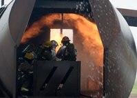 ALTUS AIR FORCE BASE, Okla. – Members from the 97th Air Mobility Wing fight a training aircraft fire during a fire exercise at the burn pit, May 8, 2015. The wing’s fire department and leaders fought cargo, passenger and flight deck fires during training. (U.S. Air Force photo by Senior Airman Franklin R. Ramos/Released)
