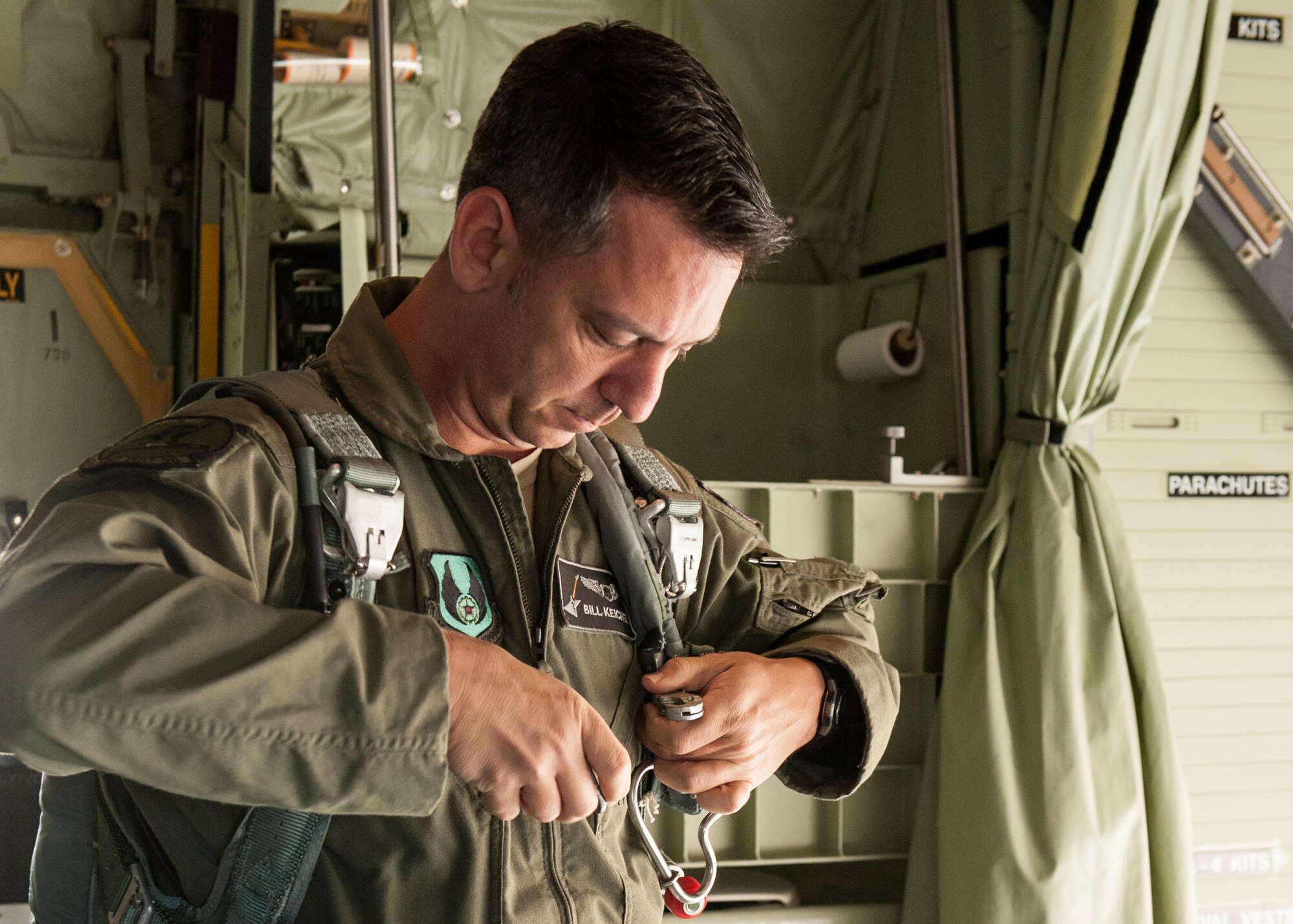William Keichel, a flight test engineer, of the 413th Flight Test Squadron, fits his parachute prior to an AC-130J flight near King Hangar at Eglin Air Force Base, Fla., March 27.  AC-130J flight crewmembers fit their parachutes prior to test missions to ensure they are prepared in case of an emergency.  The 413th FLTS plans, executes and reports development tests and evaluations for many of the Air Force’s Special Operations Command’s aircraft as well as the Air Force’s vertical lift aircraft.  (U.S. Air Force photo/Ilka Cole) 