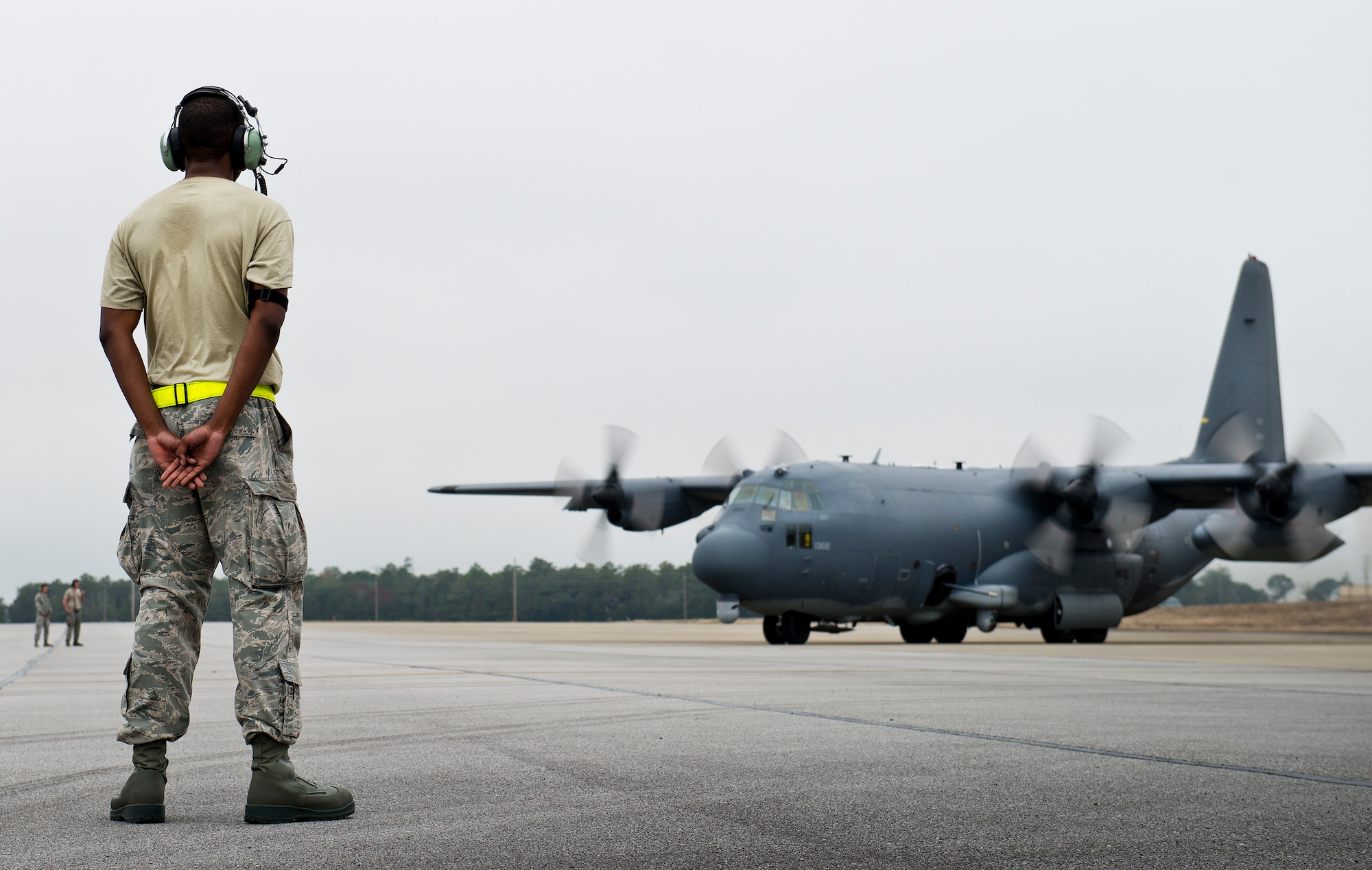 An Air Force Special Operations Command maintainer waits to marshal out an AC-130W for a test mission at Eglin Air Force Base, Fla.  The testing was conducted by the 413th Flight Test Squadron.  The 413th has three flights that perform developmental and qualification testing on Air Force Special Operations Command and rotor aircraft to include C-130s, CV-22s and UH-1s.  The three flights are geographically separated at Hurlburt Field, Eglin and Duke Field.  (U.S. Air Force photo/Samuel King Jr.)