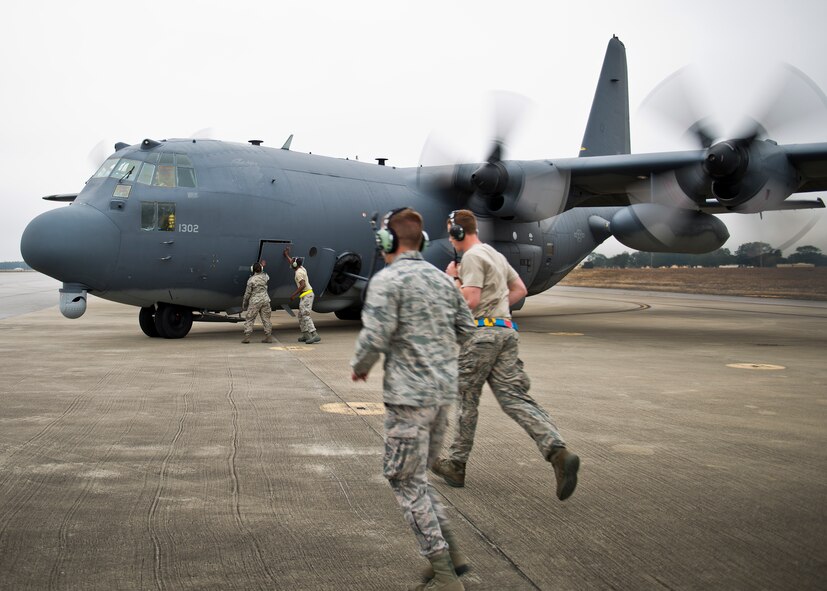 The Air Force Special Operations Command maintainers move into place prior to an AC-130W launch at Eglin Air Force Base, Fla.  The testing was conducted by the 413th Flight Test Squadron.  The 413th has three flights that perform developmental and qualification testing on Air Force Special Operations Command and rotor aircraft to include C-130s, CV-22s and UH-1s.  The three flights are geographically separated at Hurlburt Field, Eglin and Duke Field.  (U.S. Air Force photo/Samuel King Jr.)