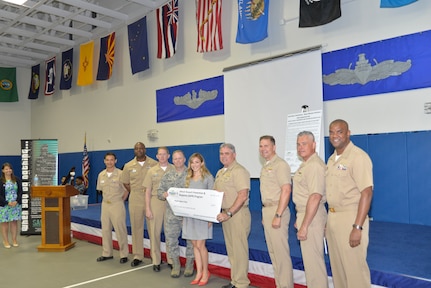 Joint Base Charleston senior leadership presents an $8,200 check to Carey Love of the People Against Rape Crisis Center during the Sexual Assault Prevention and Response Program Appreciation Luncheon April 30, 2015 at Joint Base Charleston – Weapons Station, S.C. (U.S. Air Force photo/Seamus O’Boyle)
