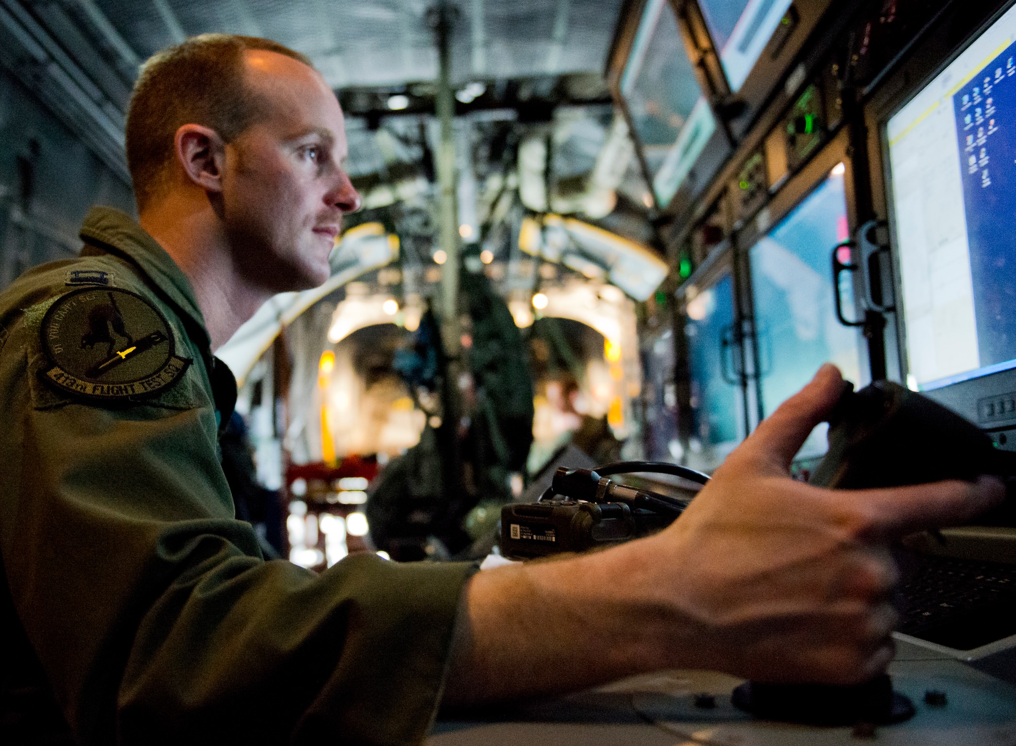Capt. Rob Newton, 413th Flight Test Squadron, prepares his work station inside an AC-130W prior to a test mission at Eglin Air Force Base, Fla.  The 413th has three flights that perform developmental and qualification testing on Air Force Special Operations Command and rotor aircraft to include C-130s, CV-22s and UH-1s.  The three flights are geographically separated at Hurlburt Field, Eglin and Duke Field.  (U.S. Air Force photo/Samuel King Jr.)
