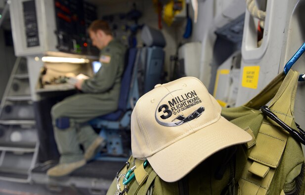 Captain Timothy Birt, 437th Airlift Wing, completes preflight checklists prior to the C-17’s departure to Joint Base Charleston S.C. The hat in the foreground was in recognition of the 3 millionth flying hour for the airframe. (U.S. Air Force photo by Tommie Horton)