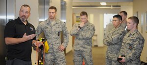 Kelly Byrne,  a Washington D.C. firefighter and rope-rescue instructor, teaches 11th Civil Engineer Squadron firefighters about various knots used during elevator rescues May 6, 2015, on Joint Base Andrews, Md. Tying or connecting to a knot incorrectly could be fatal, so firefighters have to know how and when to use each knot required for different situations. (U.S. Air Force photo by Senior Airman Preston Webb)