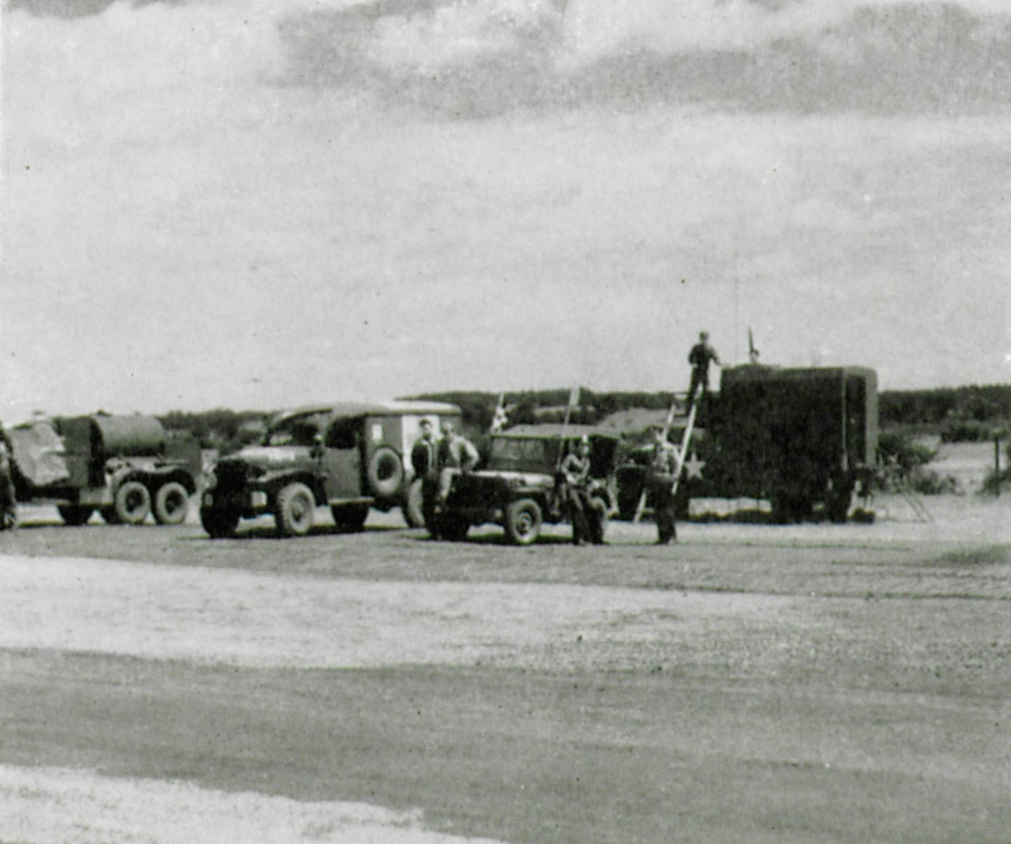 Ready on the flightline are representative vehicles from several of the units attached to the 371st Fighter Group during the war.  Present in the picture are vehicles of the Firefighters, Medics and Flying Control.  Motor transport and specialty vehicles were a great help to the conduct of expeditionary air operations.  (The Story of the 371st Fighter Group in the E.T.O.)