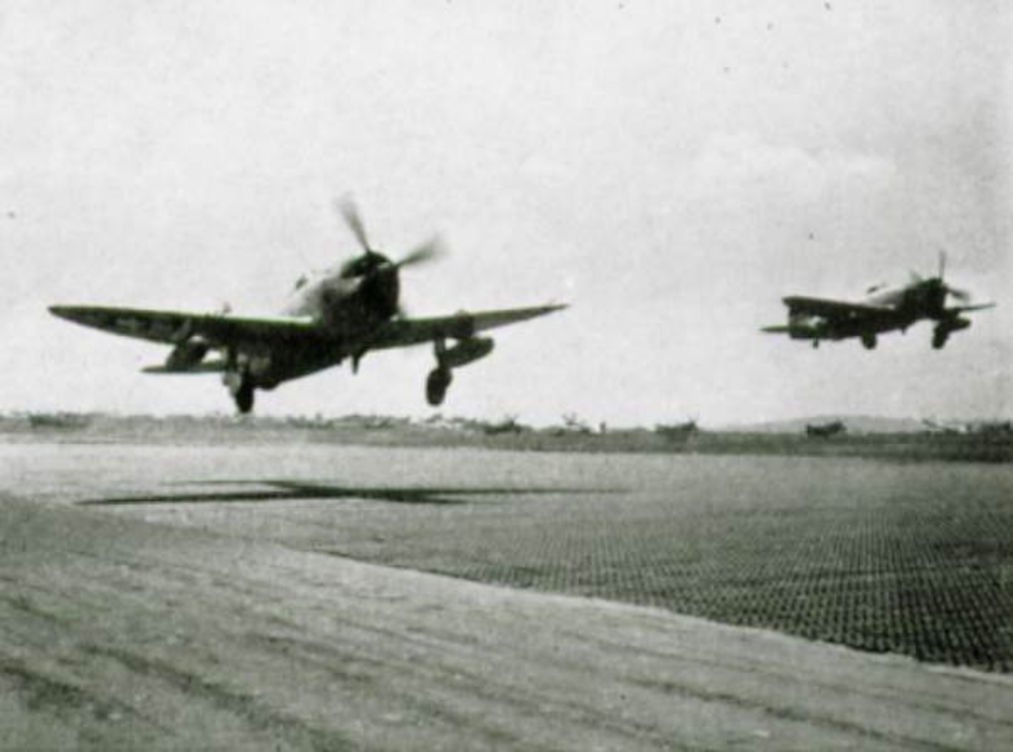 A pair of 371st Fighter Group P-47 Thunderbolt fighters on takeoff from an airfield in Europe.  The Republic P-47 Thunderbolt fighter was the primary aircraft assigned to the 371st Fighter Group during World War II.  The group operated both the Razorback and Bubbletop versions of the Thunderbolt, including those produced at Republics primary factory at Farmingdale, New York as well as its wartime factory at Evansville, Indiana.  (The Story of the 371st Fighter Group in the E.T.O.)