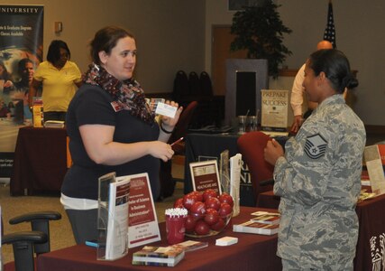 Master Sgt. Alicia Gilbert, 315th Airlift Control Flight speaks with a representative from the College of Charleston May 6, 2015 during the Education Fair held at Joint Base Charleston, S.C. Schools such as The University of South Carolina, Columbia College of Missouri and Colorado State University had representatives on hand to meet with Airmen about continuing their education. In all, 20 different colleges and vocational schools participated in the Education Fair. Veterans Affairs was there to answer any benefits questions and the Air Base librarians assisted Airmen who are utilizing the College Level Examination Program to further their education in how the library can assist them in their studies. (U.S. Air Force photo / Trisha Gallaway)