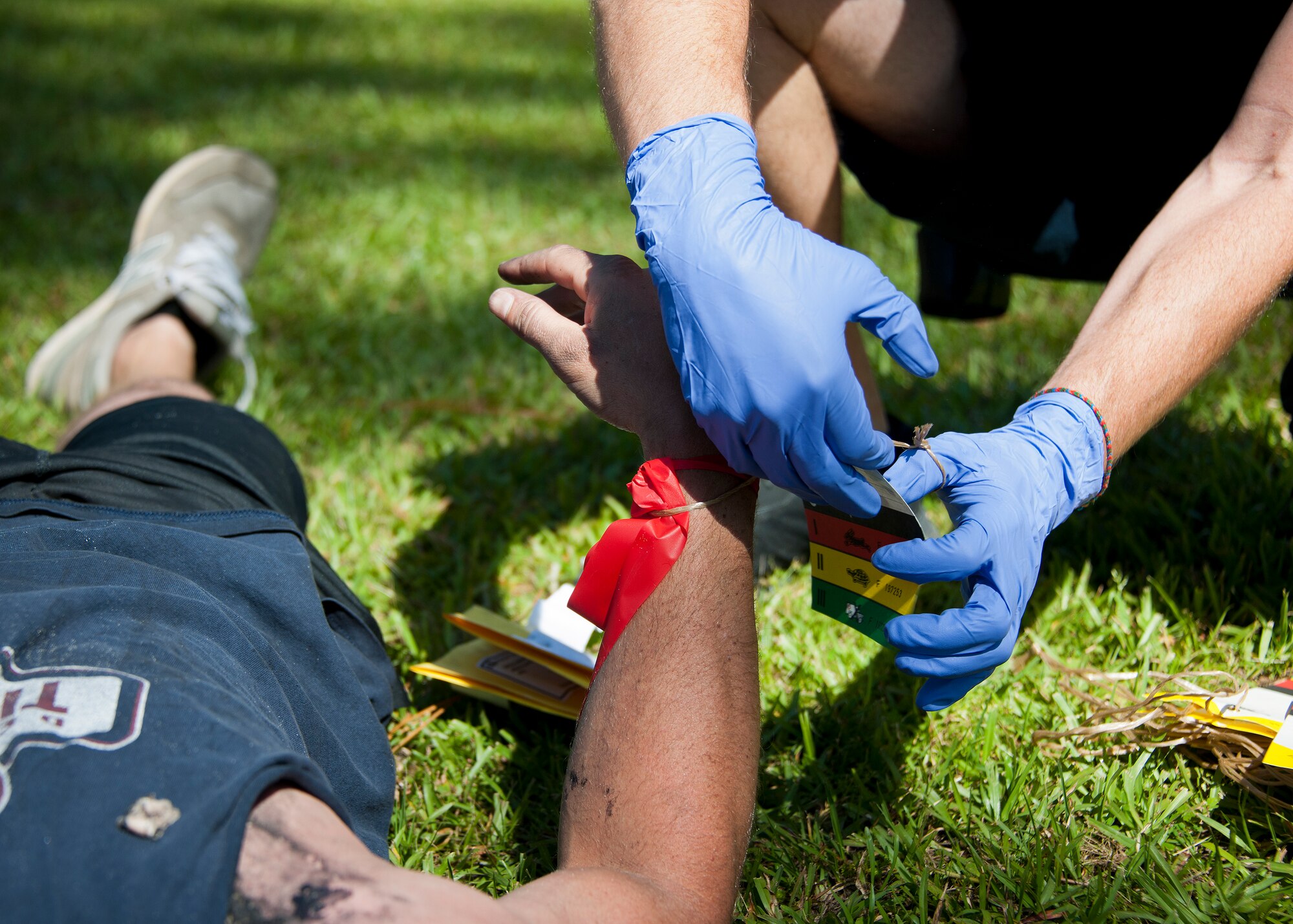An emergency services member places a card on the wrist of a simulated aircraft crash victim during a major accident response exercise in Valparaiso, Fla., May 5.  This large-scale joint exercise tested the response times and actions of base and local fire, emergency services and police personnel to an aircraft crash in local area waters.  Police, fire and medical technicians from Eglin, Valparaiso and Niceville participated in the exercise.  (U.S. Air Force photo/Samuel King Jr.)
