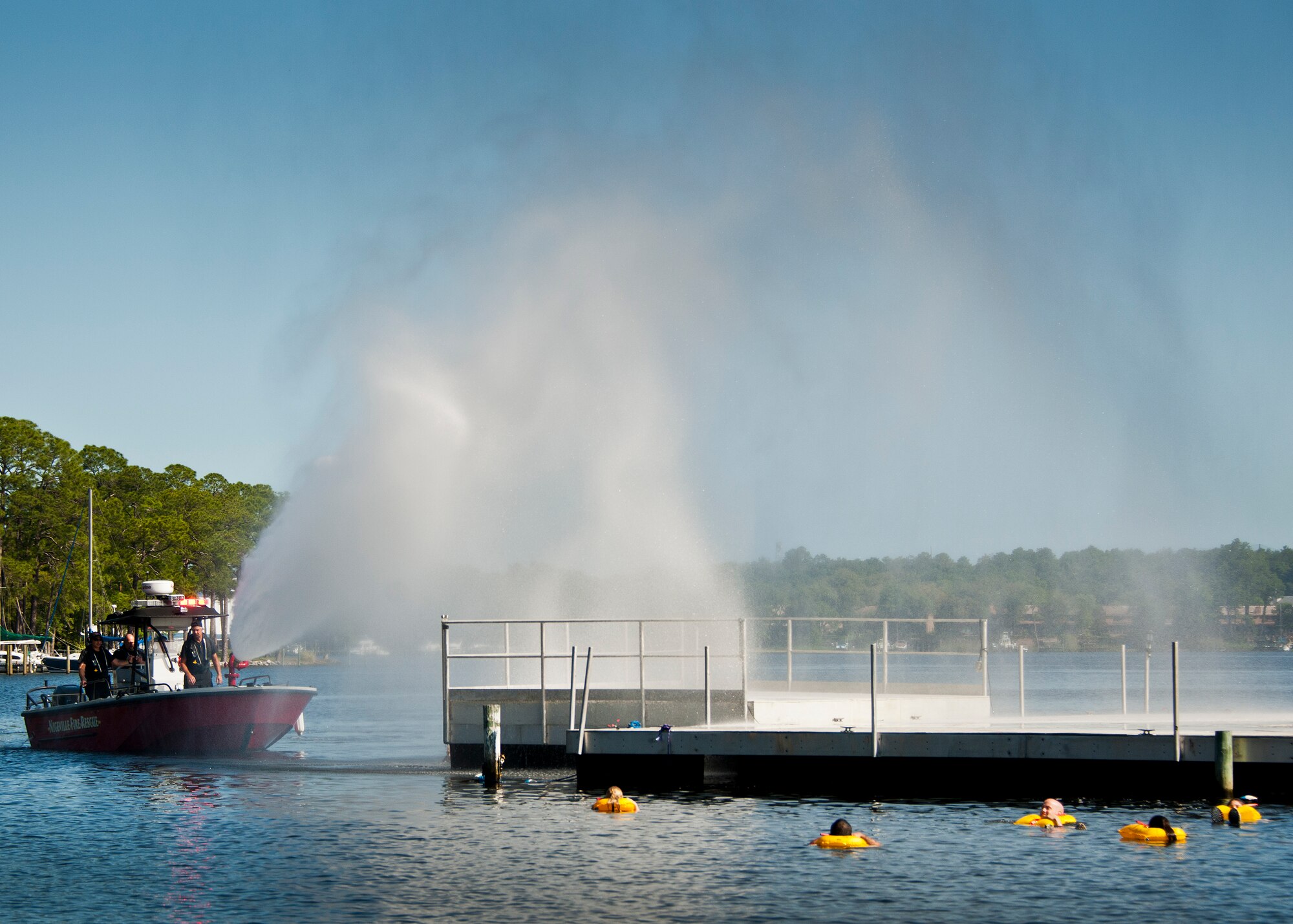 A Niceville fire department boat sprays down a simulated fiery aircraft fuselage as victims float in the water during a major accident response exercise in Valparaiso, Fla., May 5.  This large-scale joint exercise tested the response times and actions of base and local fire, emergency services and police personnel to an aircraft crash in local area waters.  Police, fire and medical technicians from Eglin, Valparaiso and Niceville participated in the exercise.  (U.S. Air Force photo/Samuel King Jr.)