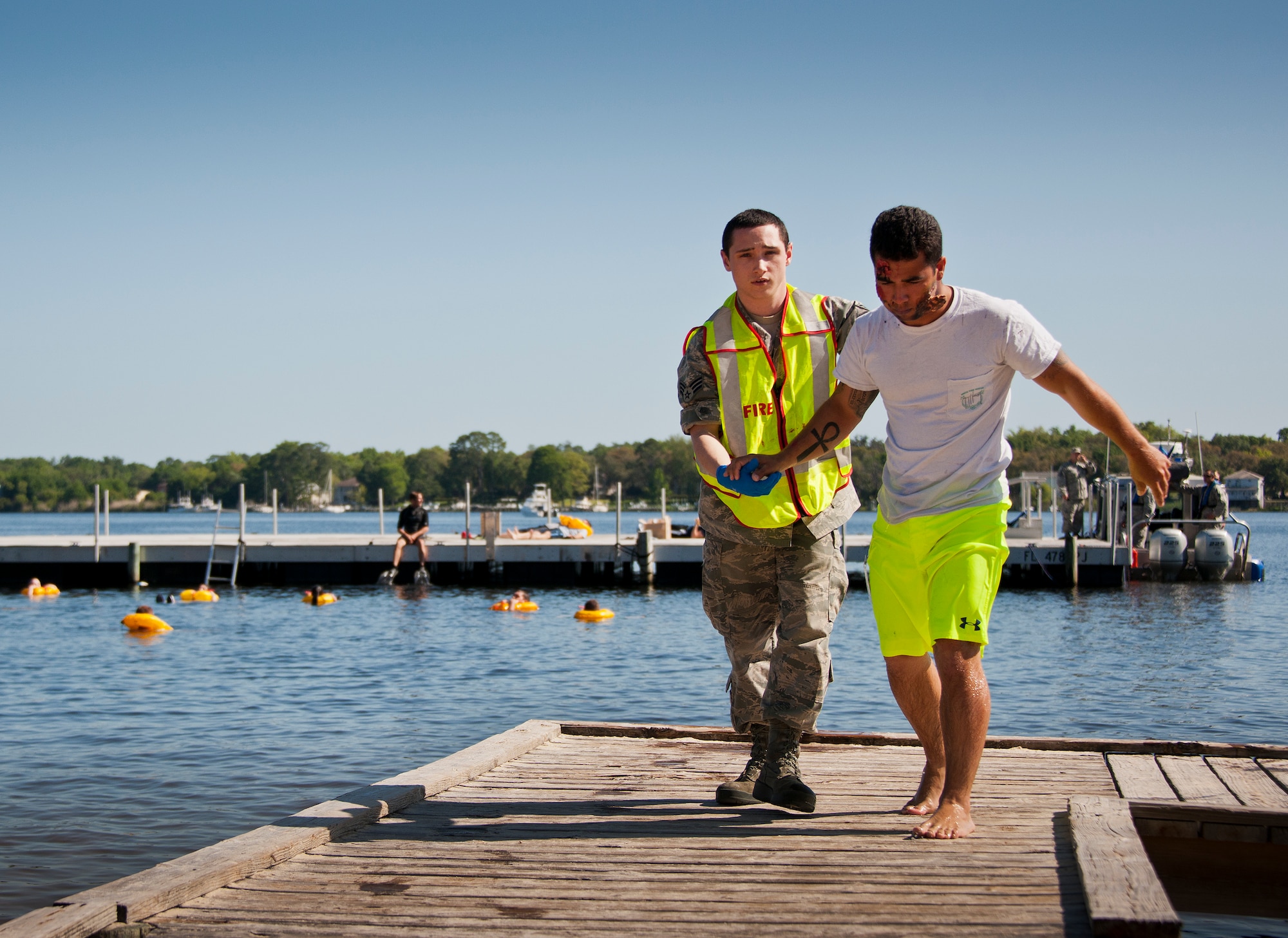 Senior Airman Nicholas Novak, 96th Medical Group, helps a simulated aircraft crash victim to safety during a major accident response exercise in Valparaiso, Fla., May 5.  This large-scale joint exercise tested the response times and actions of base and local fire, emergency services and police personnel to an aircraft crash in local area waters.  Police, fire and medical technicians from Eglin, Valparaiso, Niceville and Okaloosa County participated in the exercise.  (U.S. Air Force photo/Samuel King Jr.)