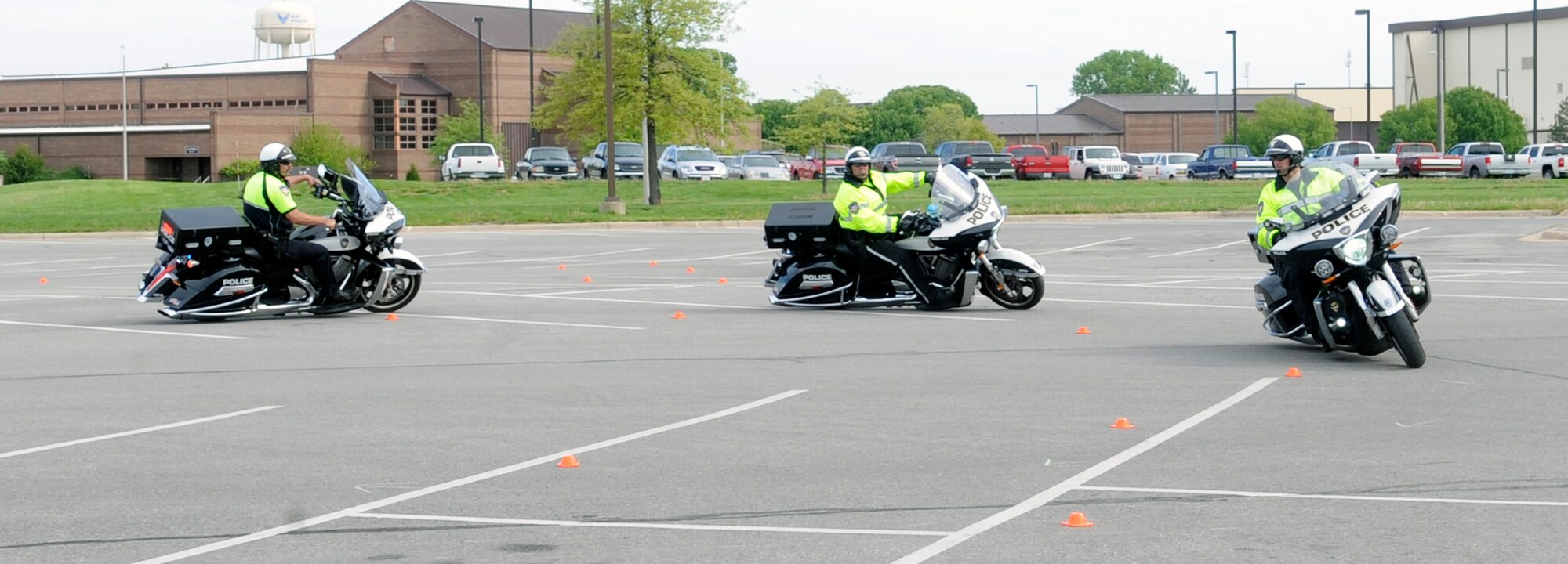 Three officers from the Lee’s Summit, Missouri Police Department participate in a demonstration on the safety course during Motorcycle Safety Day at Whiteman Air Force Base, Mo., April 27, 2015. First-time riders, seasoned veterans and anyone who enjoys motorcycles were encouraged to come out and learn about motorcycle safety. (U.S. Air Force photo by Staff Sgt. Alexandra M. Longfellow/Released)