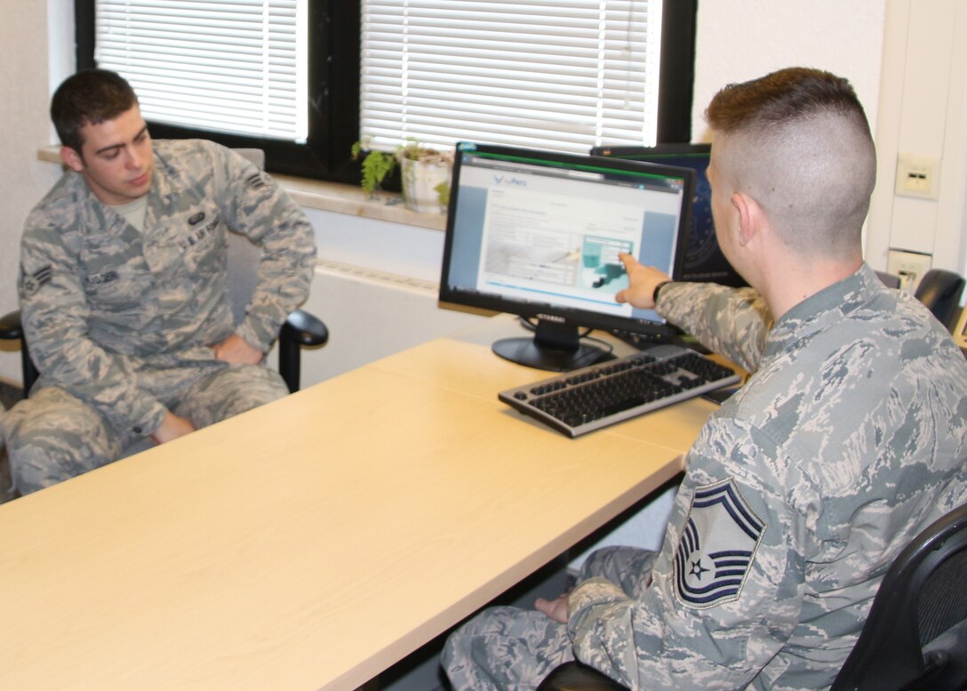 Senior Master Sgt. Nicholas Kollett, Enlisted Force Development Manager, Joint Force Headquarters, Massachusetts Air National Guard, Hanscom, Air Force Base, Mass., trains an active-duty member , on the Virtual Personnel Center (vPC) program, Ramstein Air Force Base, Germany, May 7, 2015. The active duty is currently using the Evaluation Management System (EMS) that is being phased out, requiring them to transition to vPC by September of this year.  (U.S Air Force photo by Master Sgt. Kevin Martin/Released)