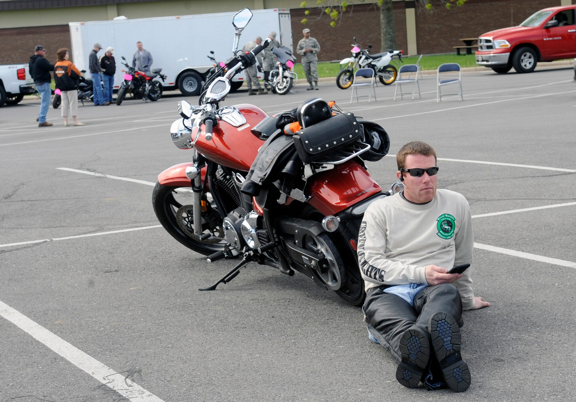 U.S. Air Force Capt. James Campbell, 509th Medical Group physician assistant, relaxes near his bike during Motorcycle Safety Day at Whiteman Air Force Base, Mo., April 27, 2015. More than 50 individuals were in attendance to promote motorcycle safety and mentorship. (U.S. Air Force photo by Staff Sgt. Alexandra M. Longfellow/Released)