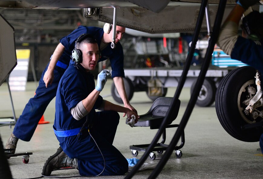 Staff Sgt. Christian Rodriguez-Tanon, a Crew Chief assigned to the 51st Maintenance Squadron F-16 Phase Docks, directs a landing gear check at Osan Air Base, Republic of Korea, 16 April 2015. Crew Chiefs work around the clock at depaneling and inspecting all standard carded items such as the wings, landing gear and fuselage as well as performing preventive maintenance on the jet as a whole.  
(USAF photo by Staff Sgt. Amber Grimm)
