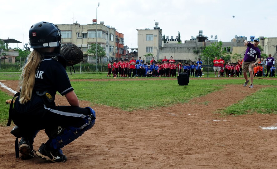 Col. Craig Wills, 39th Air Base commander, throws the first pitch of the season May 2, 2015, at Incirlik Air Base, Turkey. The youth sports baseball season started with a ceremony that recognized the families, friends and volunteers who make the season possible. (U.S. Air Force photo by Staff Sgt. Caleb Pierce/Released)  