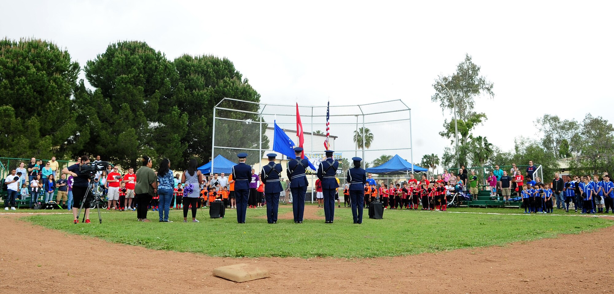 The U.S. and Turkish National anthems are played at the being of the Incirlik Youths Sports baseball season May 2, 2015, at Incirlik Air Base, Turkey. The season kicked off with Col. Craig Wills, 39th Air Base Wing commander, throwing the first pitch. (U.S. Air Force photo by Staff Sgt. Caleb Pierce/Released)