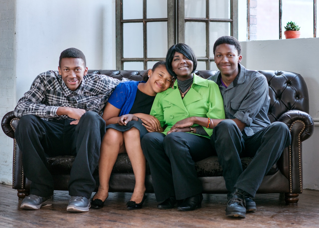 Army Sgt. 1st Class Heather West of the 402nd Field Artillery Brigade poses with her children, C.J., 16, Dasanah, 11, and Aaron, 15, in El Paso, Texas, April 28, 2015. West started volunteering in the El Paso community three years ago and her children joined her shortly thereafter. Dasanah received the Fort Bliss Outstanding Youth Volunteer award last month. U.S. Army photo by Sgt. 1st Class David Parish