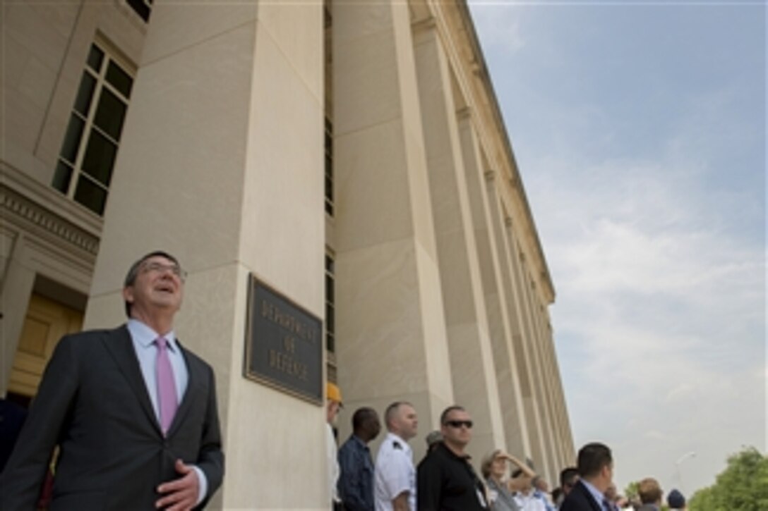 Defense Secretary Ash Carter views the Arsenal of Democracy event, which includes vintage World War aircraft as they fly over the National Mall, from the Pentagon, May 8, The event marked the 70th anniversary of V-E Day.