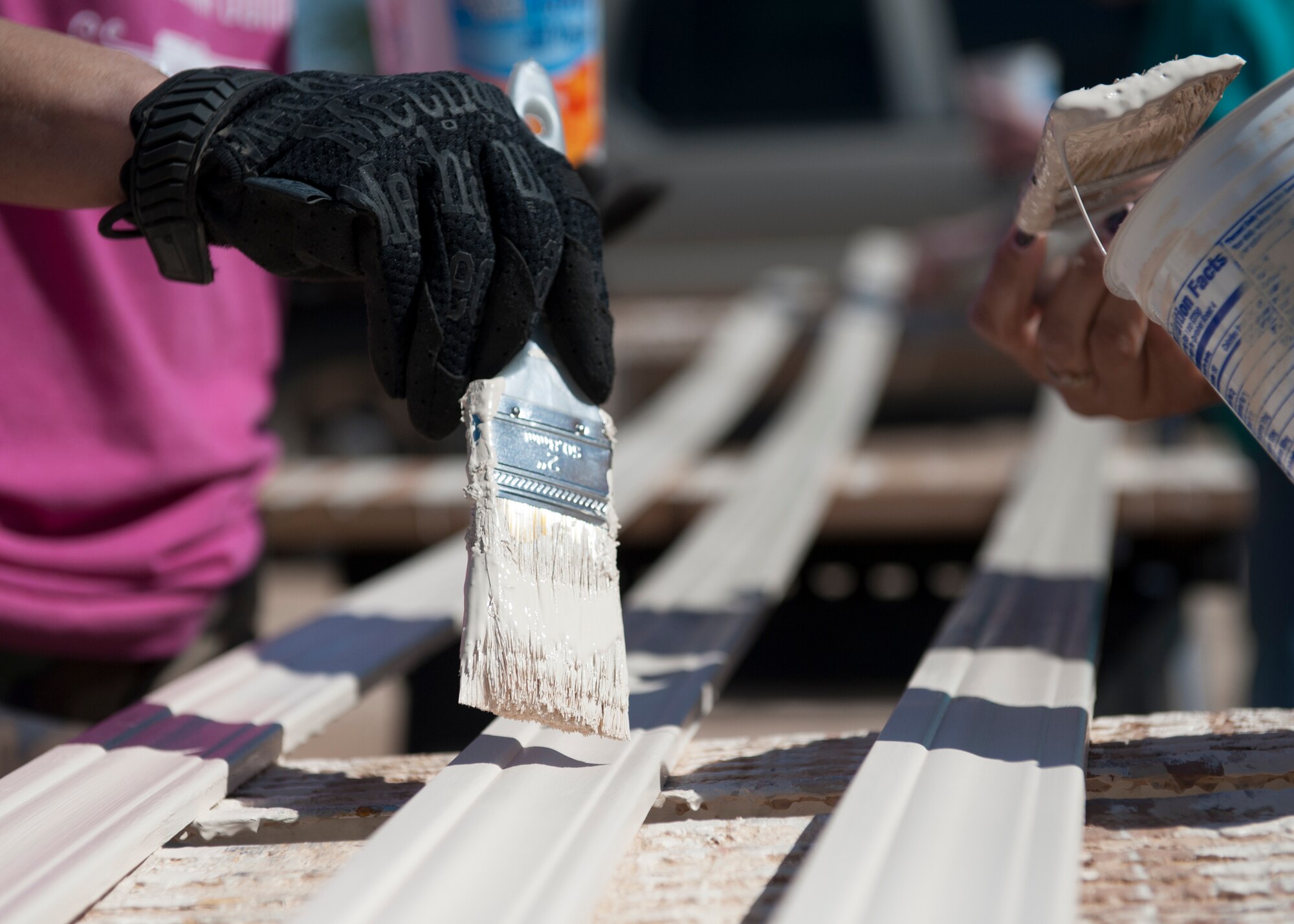 Volunteers from Team Holloman and the local community finish painting for Habitat for Humanity at a construction site in downtown Alamogordo, N.M., May 9, 2015. The volunteers and the future homeowners completed various projects in preparation for move in day for the family. The all-female crew took on different tasks from painting, landscaping, and construction with the help from local experts also volunteering their time. (U.S. Air Force photo by Senior Airman Leah Ferrante/released)