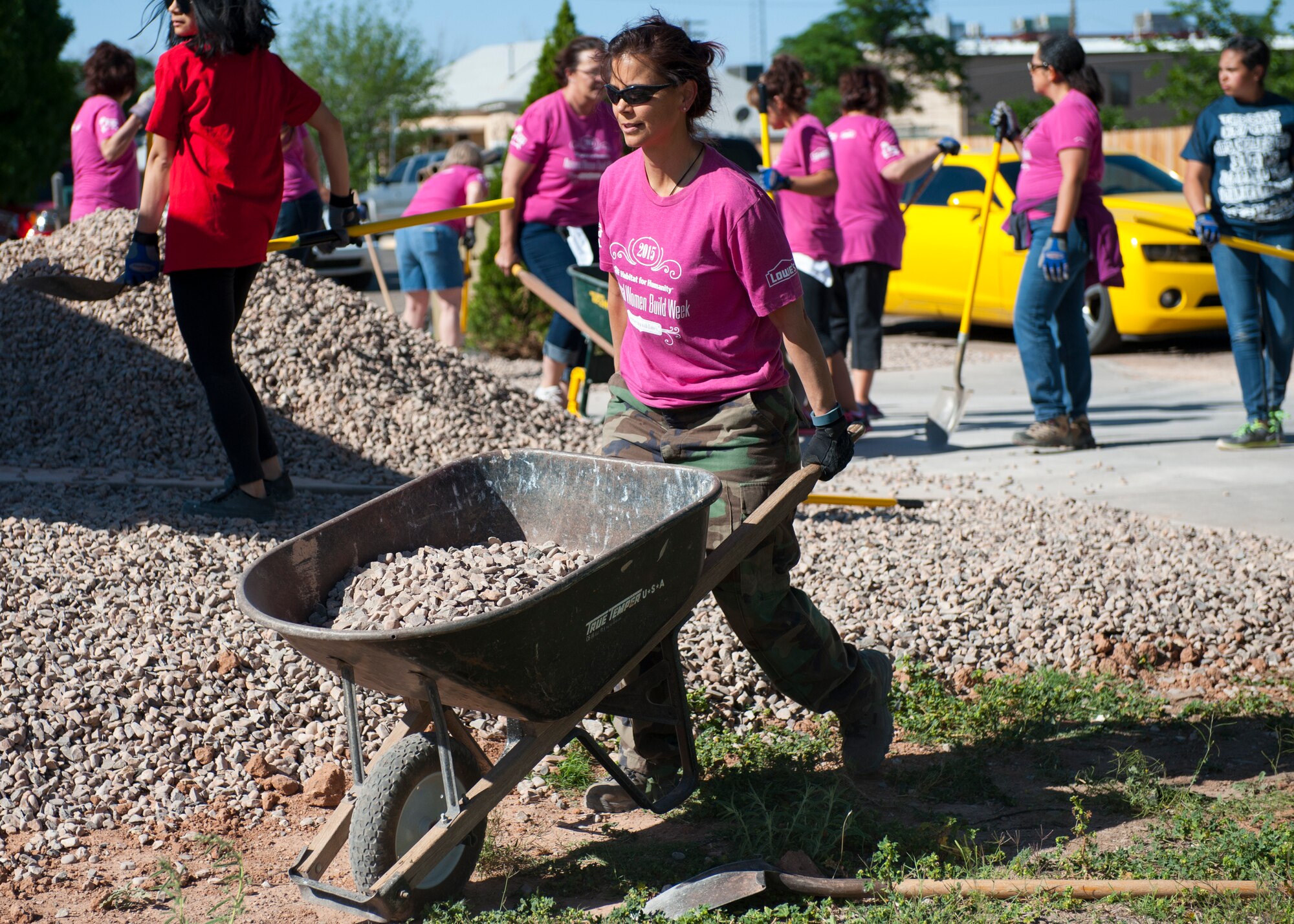 Colonel Leslie Knight, 49th Medical Group commander, helps finish landscaping at a local Habitat for Humanity site in downtown Alamogordo, N.M., May 9, 2015. Knight participated in National Women Build Week, an annual event hosted by Habitat for Humanity where multiple volunteers devote their time to come together to help members of the community who are less fortunate. Knight also spoke to the volunteers and new homeowners during the event. “The theme Women Build really struck me because women do build, we build our homes we build our communities and families, and now we’re building houses,” said Knight. “What a great theme and idea, and I’m so glad I could be a part of it.” (U.S. Air Force photo by Senior Airman Leah Ferrante/released)