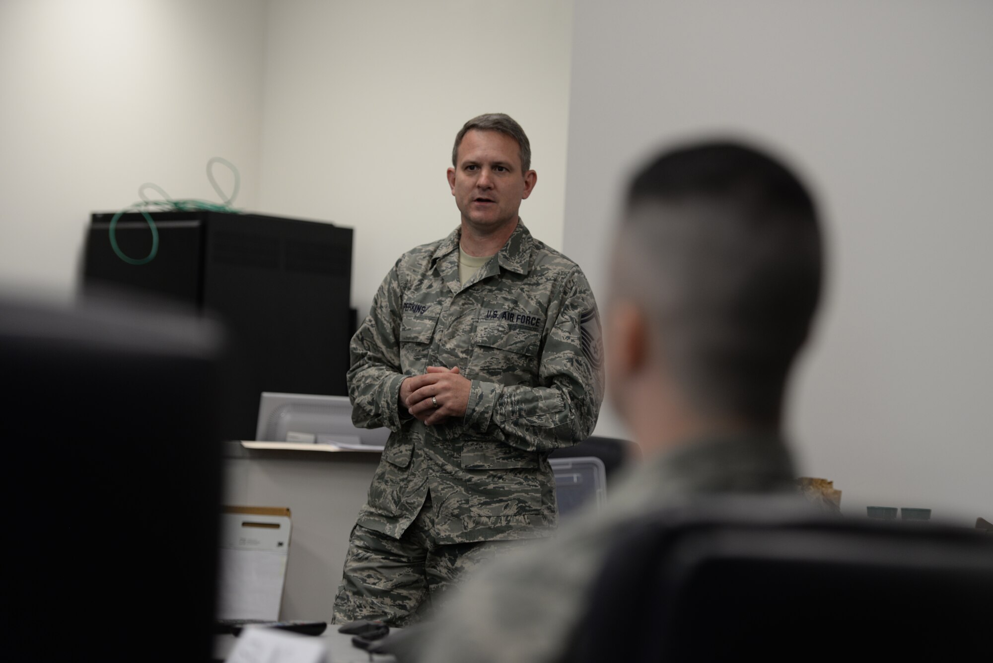 Senior Master Sgt. Leonard Perkins, facilitator for Satellite Airman Leadership School class 15-6, speaks to students at Pease Air National Guard Base, N.H., May 9. Ten senior airman are attending the first ALS class offered at Pease. (U.S. Air National Guard photo by Staff Sgt. Curtis J. Lenz)