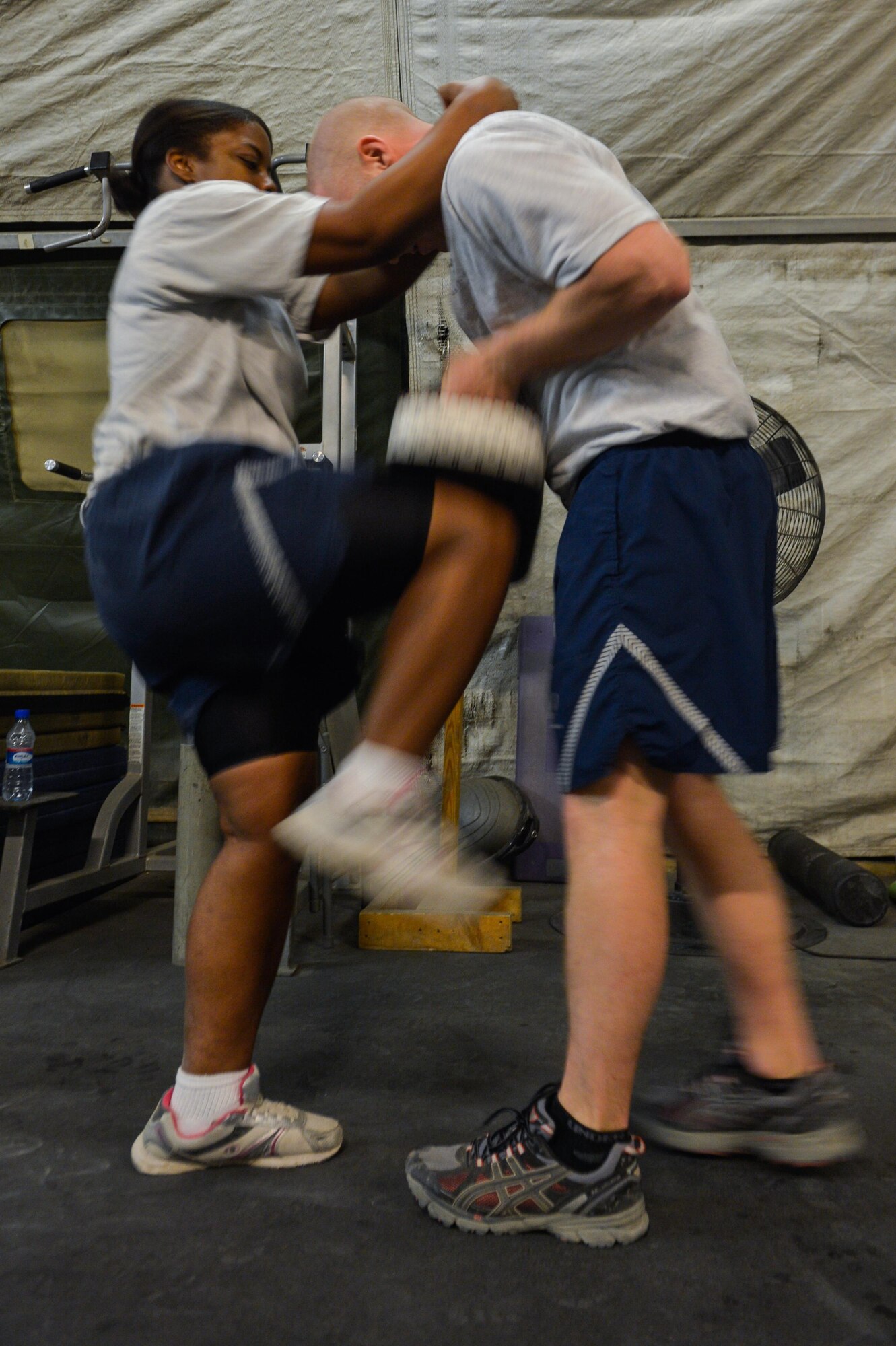 U.S. Air Force Senior Airman Tiffany Hamilton, left, 455th Expeditionary Medical Operations Squadron medical technician, and Tech. Sgt. Cole Anderson, 455th Expeditionary Aeromedical Evacuation Squadron technician, practice Krav Maga techniques during a bi-weekly class at Bagram Airfield, Afghanistan, May 7, 2015. The training helps Airmen better understand how to defend themselves where they live and work while in a combat environment. (U.S. Air Force photo by Tech. Sgt. Joseph Swafford/Released)