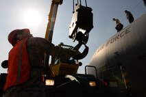 Tech. Sgt. Mike Massey, pavements and equipment NCO in charge with the 374th Civil Engineer Squadron, steadies the hook block of a crane, April 29, 2015 at Yokota Air Base, Japan. The crane lifted the engines off the wings of a C-130 Hercules for repairs. (U.S. Air Force photo by Airman 1st Class Elizabeth Baker/Released)