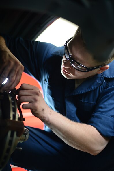 374th Logistics Readiness Squadron vehicle maintenance journeyman, Senior Airman Brandon Higginbotham, installs new brakes on a government vehicle at Yokota Air Base, Japan, April 28, 2015. Higginbotham determined that the damage to the breaks resulted from normal wear and tear. (U.S. Air Force photo by Airman 1st Class David C. Danford/Released))