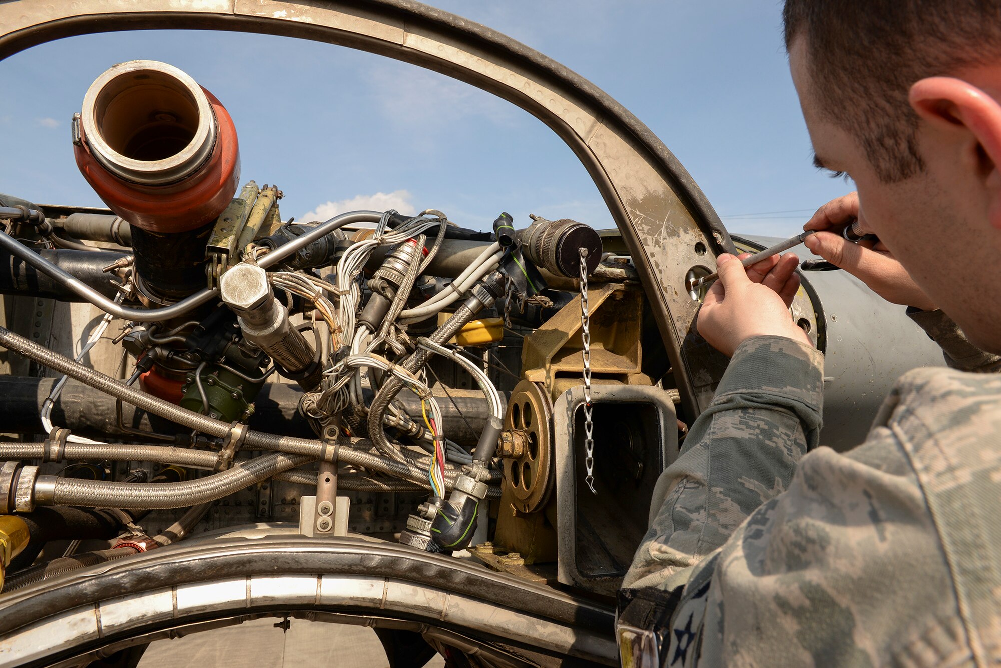 Airman 1st Class Curtis Doherty, aircraft metals technology journeyman with the 374th Maintenance Squadron, measures receptacles on a C-130 Hercules wing, April 29, 2015 at Yokota Air Base, Japan. The measurements are taken down to fractions of millimeters to check for damages. (U.S. Air Force photo by Airman 1st Class Elizabeth Baker/Released)