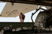 An Airman with the 374th Maintenance Squadron performs repairs on the engine of a C-130 Hercules, April 29, 2015 at Yokota Air Base, Japan. The 374 MXS and the 374th Aircraft Maintenance Squadron conducted a rare operation by removing all four engines from the C-130 H in one day, which none of the maintainers had done before. (U.S. Air Force photo by Airman 1st Class Elizabeth Baker/Released)