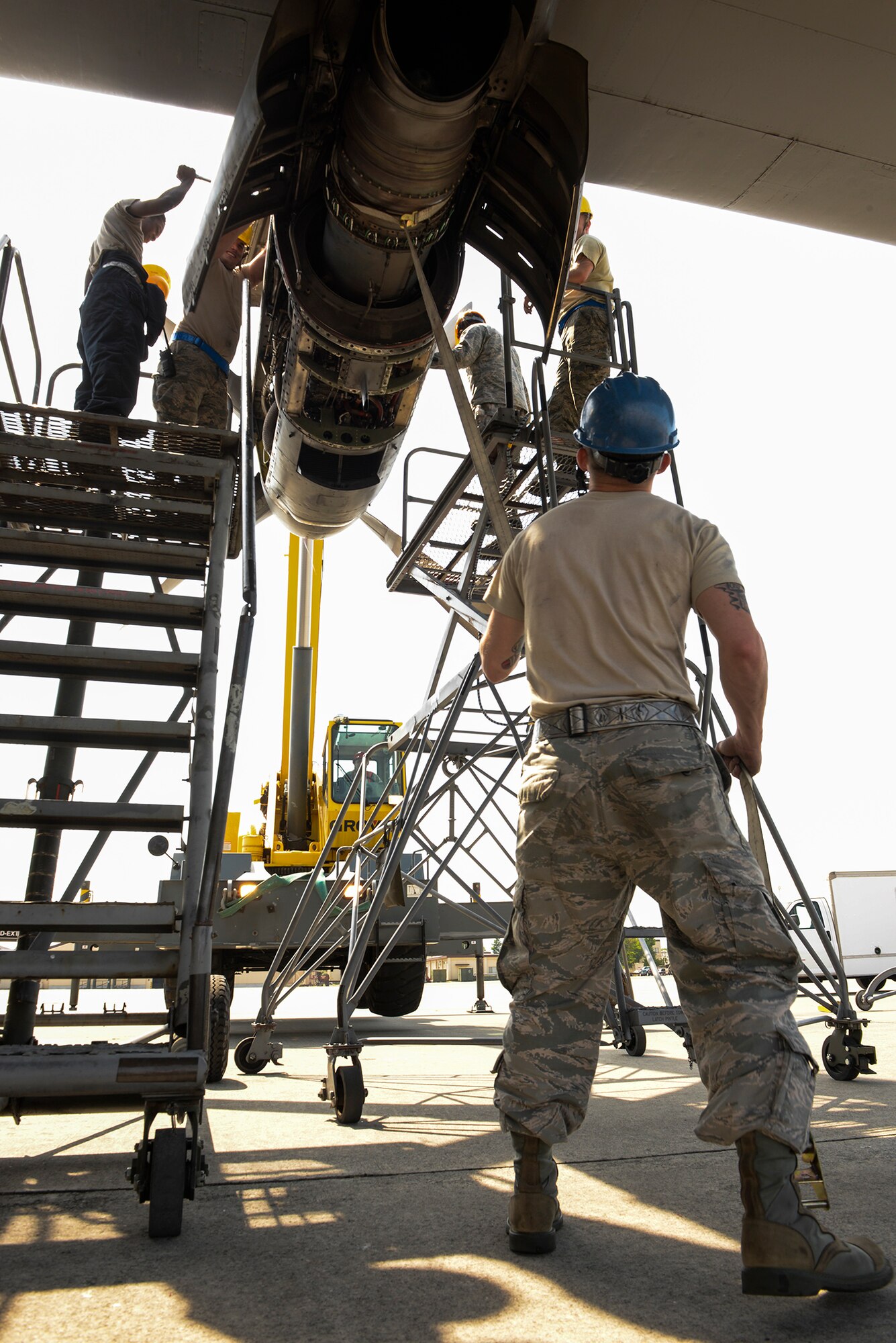 Staff Sgt. Dwayne Trett, aerospace propulsion craftsman with the 374th Maintenance Squadron, holds a strap to steady the engine of a C-130 Hercules, April 29, 2015 at Yokota Air Base, Japan. The process of removing the engine for repair took about 45 minutes of care and precision. (U.S. Air Force photo by Airman 1st Class Elizabeth Baker/Released)