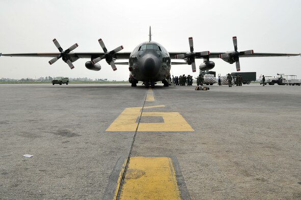 Nepalese army soldiers and U.S. Air Force 36th Contingency Response Group Airmen work with Republic of Singapore Air Force members to unload relief supplies from an RSAF C-130 Hercules May 9, 2015, at the Tribhuvan International Airport in Kathmandu, Nepal. The Nepalese army and Airmen worked together to process 537,816 pounds of cargo in a 24-hour period from 13 aircraft delivering relief supplies delivered in response to a magnitude 7.8 earthquake that struck the nation April 25, 2015. (U.S. Air Force photo by Staff Sgt. Melissa B. White/Released)