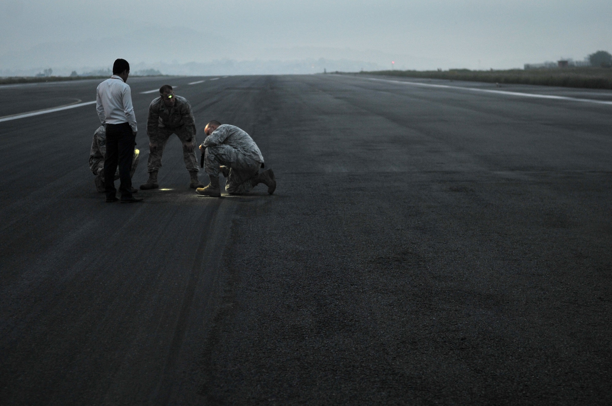 A Civil Aviation Authority Nepal member and U.S. Air Force 36th Contingency Response Group Airmen attached to Joint Task Force-505 conduct a physical assessment of the runway at the Tribhuvan International Airport in Kathmandu, Nepal, May 10, 2015. The Nepalese officials and Airmen plan to continue doing daily visual assessments to ensure the integrity of the runway remains intact and to identify any additional repairs if necessary after it sustained damage following a magnitude 7.8 earthquake that struck the nation April 25, 2015. In response to the Nepal earthquake, the U.S. military sent Airmen, Marines, Soldiers and Sailors as part of JTF-505 to support the humanitarian assistance and disaster relief mission in Nepal at the direction of U.S. Agency for International Development.(U.S. Air Force photo by Staff Sgt. Melissa B. White/Released)