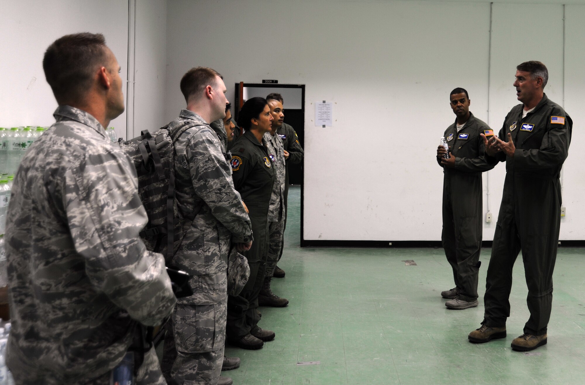 U.S. Air Force Brig. Gen. Michael Minihan, Joint Task Force-505 Joint Air Component Coordination Element commander, speaks with members of the 18th Aeromedical Evacuation Squadron as they join the JACCE team at Utapao Royal Thai Navy Airfield, Thailand, May 10, 2015. The joint operations center established in Utapao serves as a staging point for JTF-505 aviation assets and key planners conducting humanitarian aid and disaster relief operations in response to the 7.8 magnitude earthquake that struck Nepal, April 25, 2015. The 18th AES is deployed from Kadena Air Base, Japan. (U.S. Air Force photo by Staff Sgt. Alexander Martinez/Released)