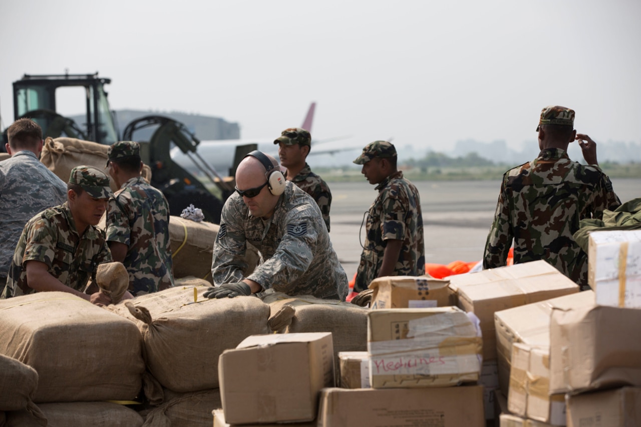 U.S. airmen and Nepalese service members dismount a pallet of humanitarian aid after an aircraft offload during Joint Task Force 505 humanitarian assistance and disaster relief at Tribhuvan International Airport in Kathmandu, Nepal, May 7, 2015. The Nepalese government requested the U.S. government's assistance after a magnitude-7.8 earthquake struck the country April 25. U.S. Marines from III Marine Expeditionary Force came together with other services to provide unique capabilities to assist Nepal. U.S. Marine Corps photo by Cpl. Sara Medina