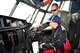 Maj. Ivan DeRoche, a pilot with the 53rd Weather Reconnaissance Squadron Hurricane Hunters, explains the flight controls to a young visitor during the Halifax, Nova Scotia stop of the 2015 Hurricane Awareness Tour May 3.