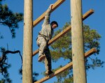 Army Staff Sgt. Tony Genovese of the Illinois National Guard makes his way down the Confidence Climb obstacle during an assessment for the 2011 Best Ranger Competition held at Fort Benning, Ga., Nov. 17, 2010.