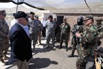 U.S. Defense Secretary Robert M. Gates, left, and Chilean Defense Minister Jaime Ravinet talk with the members of the Fuerte Lautaro, Chilean Special Forces, in Colina, Chile, Nov. 20, 2010.