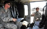 First Lt. Laz Murphy, right, an Army National Guard instructor pilot, reviews a final check of a UH-60 Black Hawk with a student.