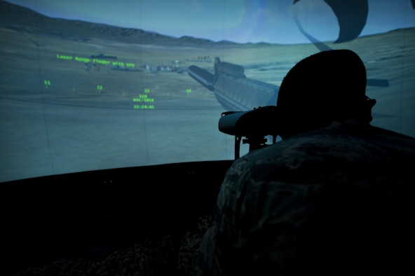 A tactical air control party Airman with the 14th Air Support Operations Squadron, surveys the landscape through a laser rangefinder inside the 6th Combat Training Squadron’s joint terminal attack controller virtual training facility at Nellis Air Force Base, Nev., April 29, 2015. Since 2013, the 6th CTS has graduated more than 500 TACP Airmen from their JTAC Qualification Course which provides them with the experience and expertise required to call for live fire. (U.S. Air Force photo/Senior Airman Joshua Kleinholz)