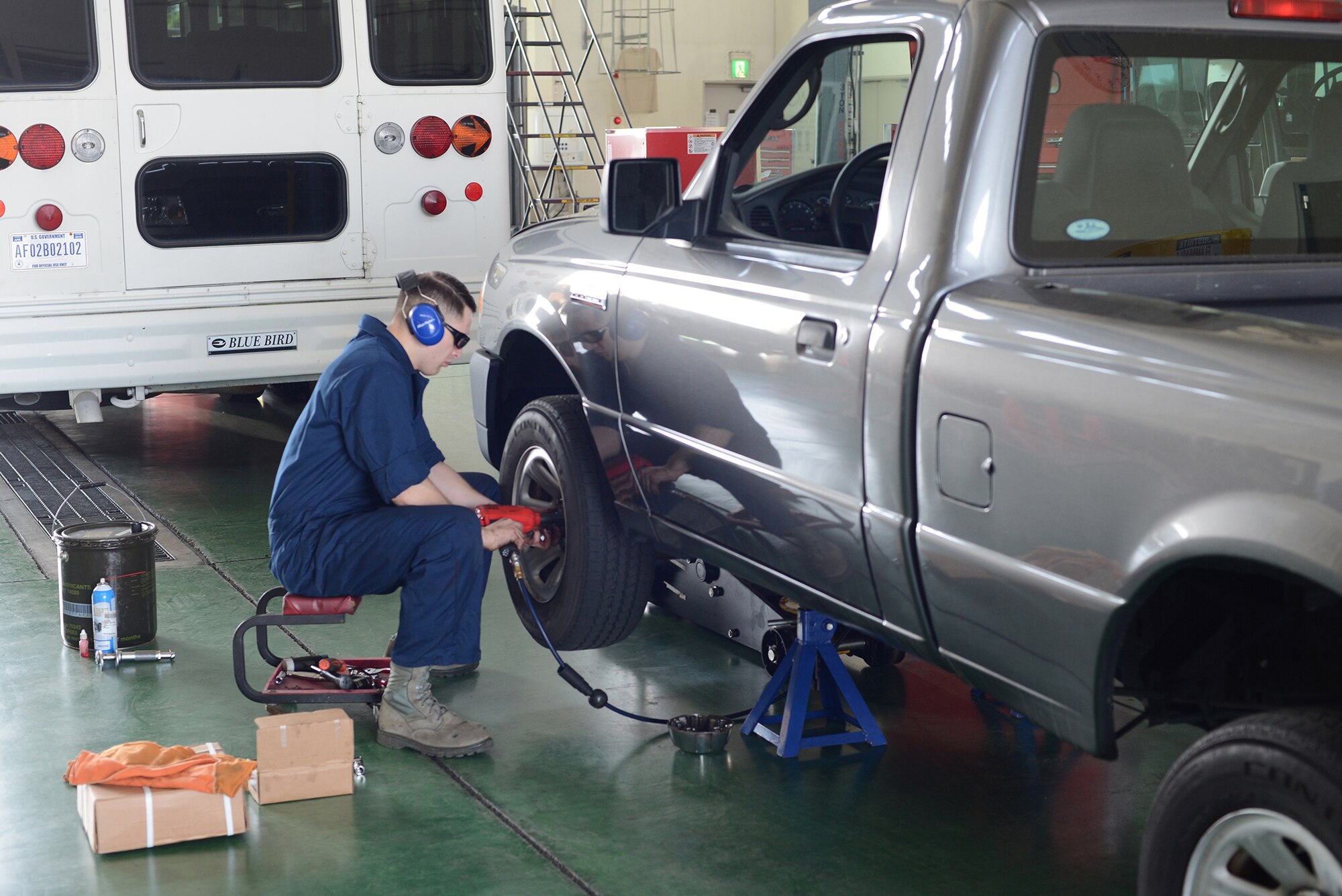 Senior Airman Brandon Higginbotham, a 374th Logistics Readiness Squadron vehicle maintenance journeyman, removes a wheel from a government vehicle at Yokota Air Base, Japan, April 28, 2015. The truck was brought into the vehicle maintenance shop to troubleshoot the front brakes. (U.S. Air Force photo/Airman 1st Class David C. Danford)