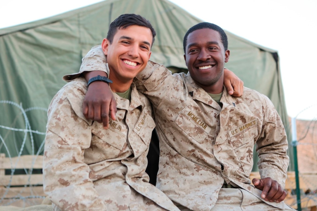 Corporals Augusto R. Carlin and Deneaga D. McMillian, supply Marines with Headquarters Battalion, 1st Marine Division, take a moment during Exercise Desert Scimitar 2015 to take a photo before both Marines return home as the exercise comes to a close aboard Marine Corps Air Ground Combat Center Twentynine Palms, Calif., April 15, 2015 . Carlin was inspired to join the military by his grandfather, George Carlin, who was a general in the Peruvian army. Although he was originally inspired to join the military by his family, he never anticipated the family he would find in the Marine Corps.
